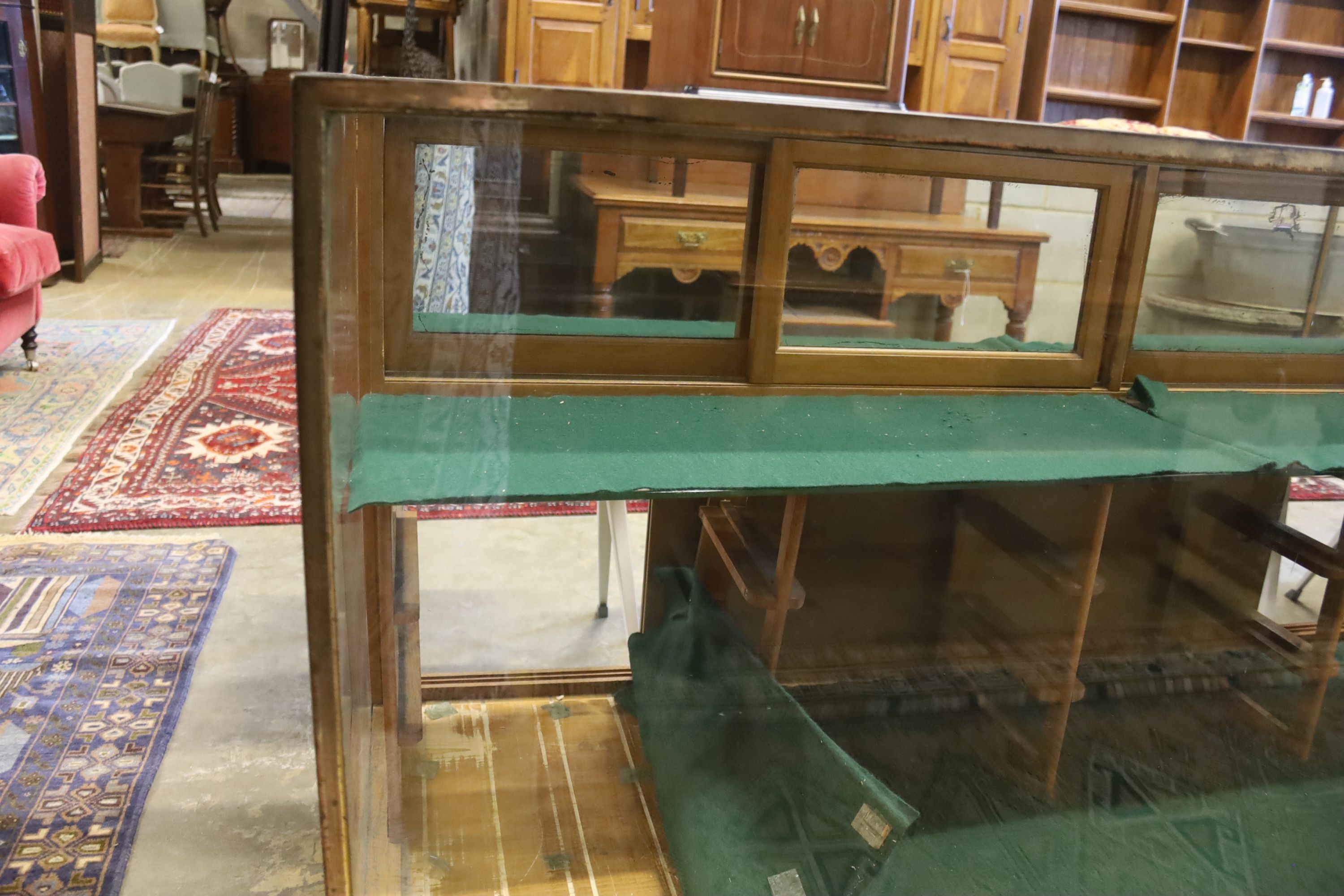 A mid 20th century brass mounted oak haberdashery cabinet, width 183cm, depth 61cm, height 91cm